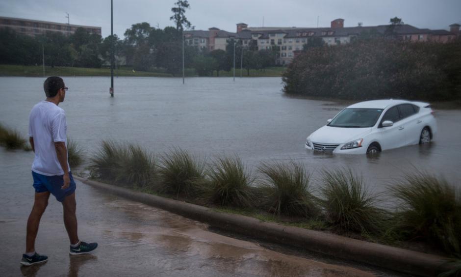 Juan Jaramillo, from Houston, went for a morning jog to survey the damage along Buffalo Bayou on Tuesday. Photo: Andrew Burton, The New York Times