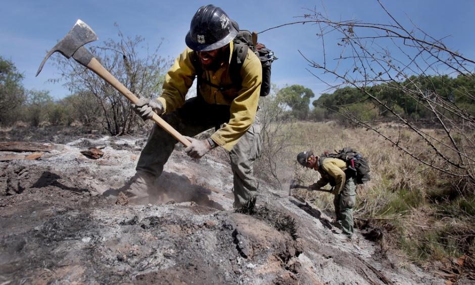 Mike Trubman, left, works with fellow Black Mesa Type-1 Interagency Hotshot Crew member Steve Daly, right, to mop up hot spots along Cienega Creek east of Empire Ranch while the Sawmill Fire burns on April 27, 2017, burning in Southeastern Arizona between Green Valley and J-6. Photo: Mike Christy, Arizona Daily Star