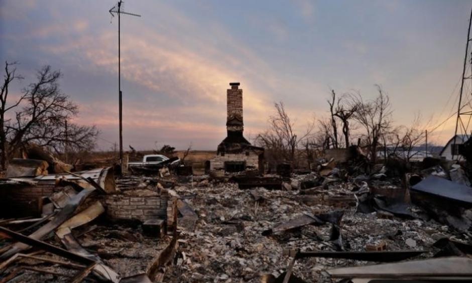 A chimney is all that stands in the footprint of a home destroyed by wildfires near Laverne, Okla., on March 12, 2017. Credit: Lucas Jackson, Reuters