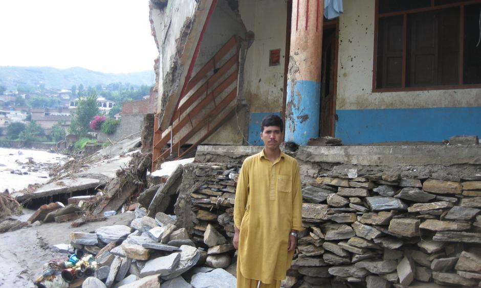 Fazal Mowla stands in front of his collapsed house in Faizabad village in Swat. Photo: Oxfam International