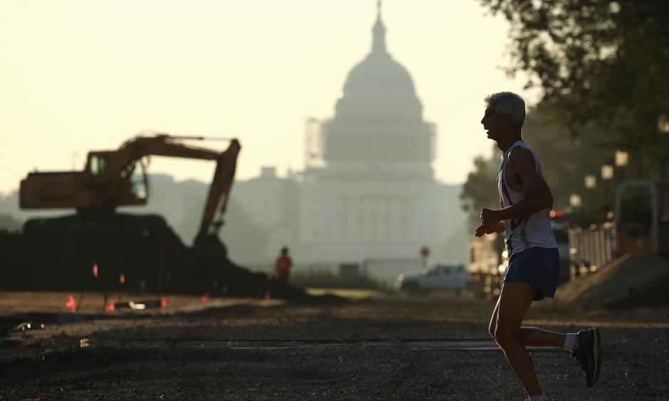 The Capitol can be seen as a jogger runs along the National Mall on July 21 in Washington, where area temperatures are forecasted to reach the upper 90s for the next few days. Photo: Mark Wilson / Getty Images