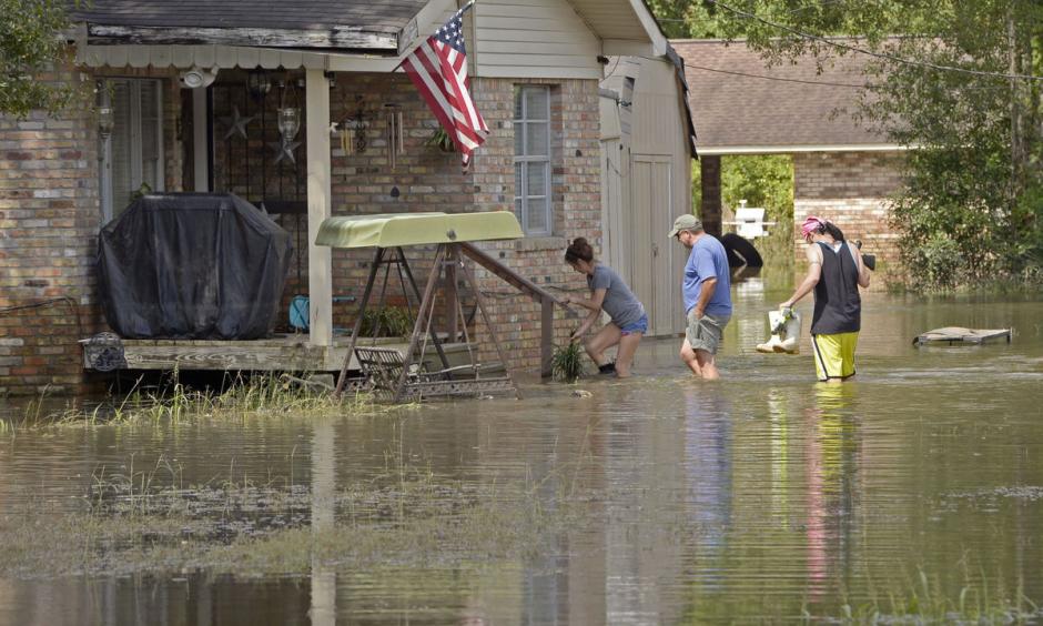 Homeowners return to their flooded home on Prince Road in St. Amant during Ascension Parish flooding and cleanup on Thursday, August 18, 2016. Photo: Bill Feig