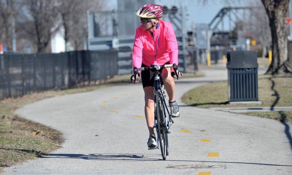 Linda Lewis of Davenport rides her bike along the path in downtown Davenport as temperatures reached in to the upper 60s on Tuesday, February 21, 2017. Photo: Gary Krambeck
