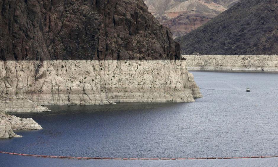 In this April 16, 2013 file photo, a "bathtub ring" marks the high water mark as a recreational boat approaches Hoover Dam along Black Canyon on Lake Mead. Photo: Julie Jacobson, AP, File