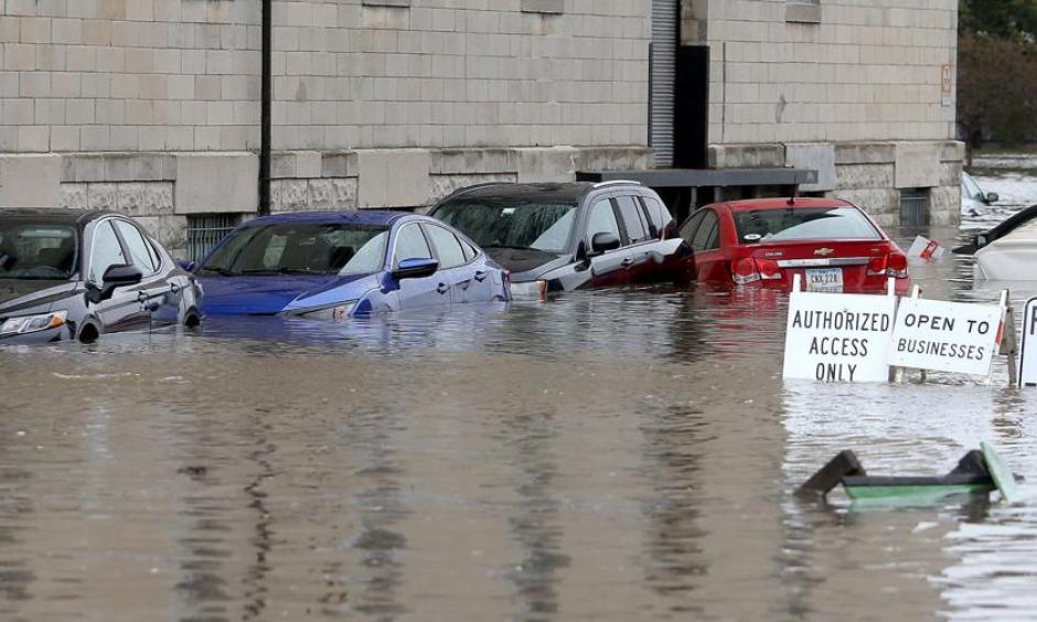 Flooded cars parked next to the Peterson Paper Loft Apartment building on Pershing Avenue at East 2nd Street in Davenport after a flood barrier was breached by Mississippi floodwaters on Tuesday. Credit: John Schultz