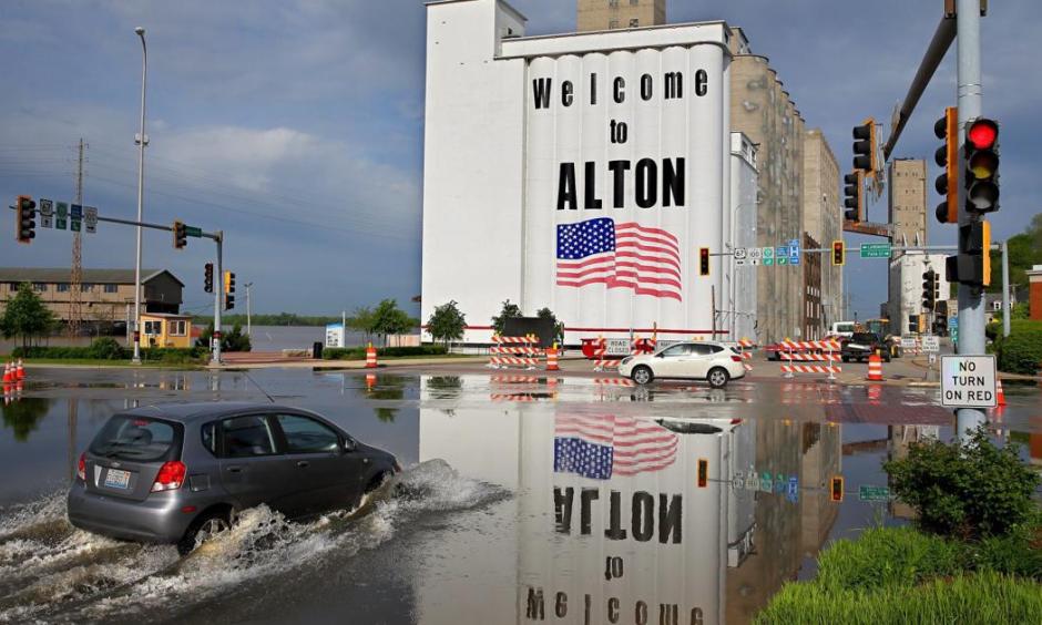A car drives through Mississippi River flood water in downtown Alton on Monday, May 6 2019. Photo: David Carson, Post Dispatch