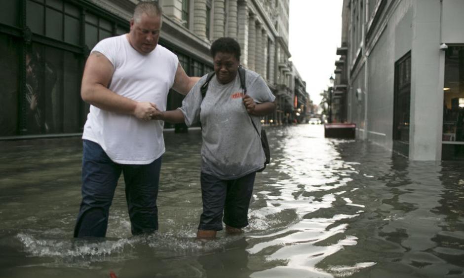 Pedestrians make their way through high water in the CBD after a downpour and flood in New Orleans. Credit: Chris Granger, NOLA
