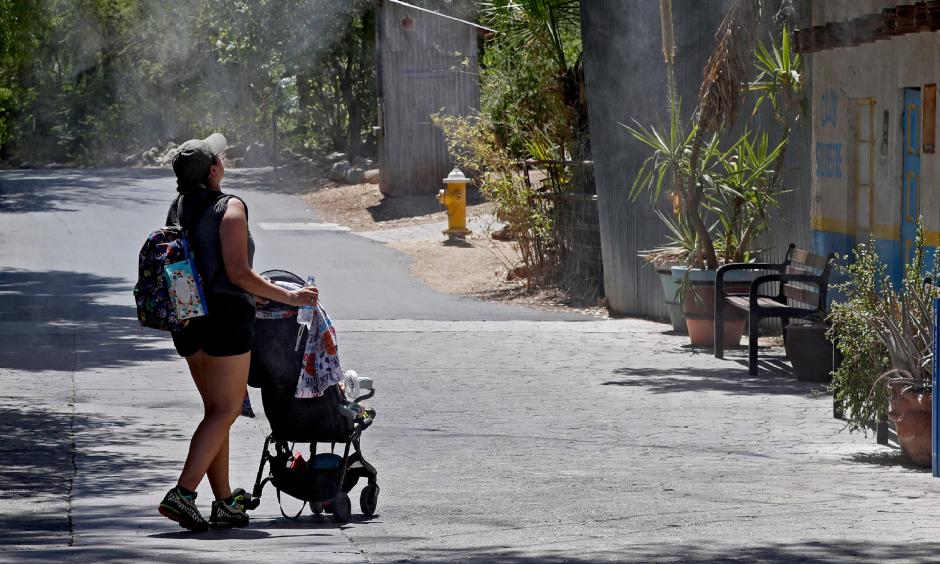 Visitors keep cool under misters at the Phoenix Zoo on July 16, 2019, in Phoenix. Credit: Matt York, AP