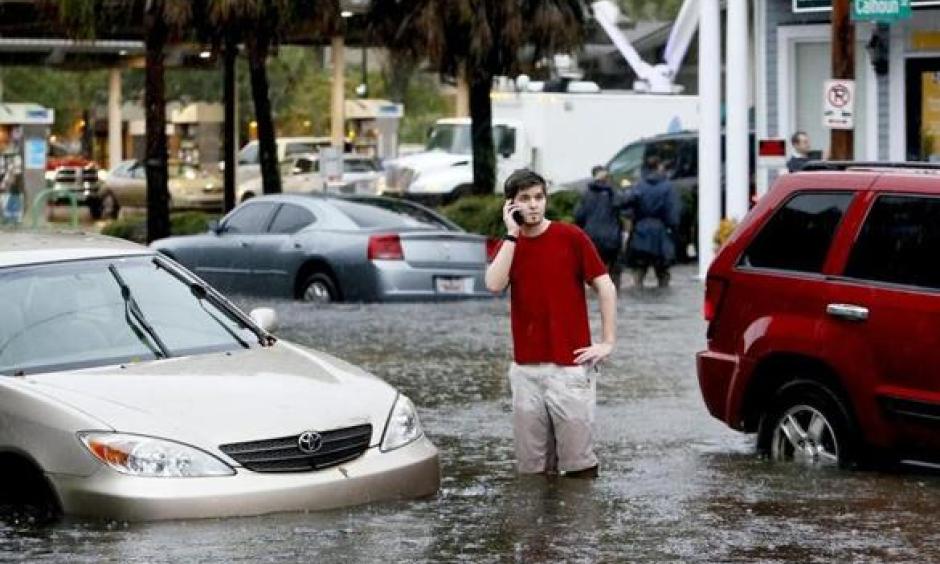A man called for help after his car stalled in floodwaters in Charleston, S.C. in October. Photo: AP