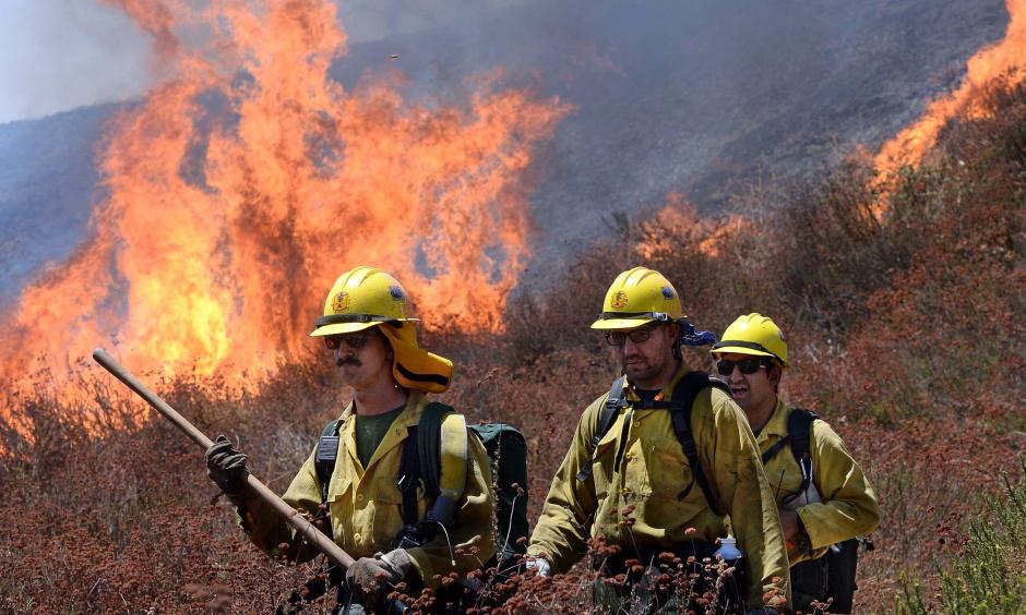 Firefighters battle the Blue Cut Fire along Swarthout Canyon Road in the Cajon Pass, north of San Bernardino, California, on Aug. 16, 2016. Photo: Will Lester, The Sun via AP