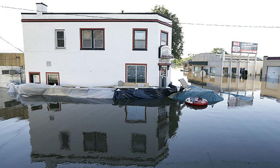 The Tornado's Grub & Pub sits surrounded in flood waters from the Cedar River, Tuesday, Sept. 27, 2016, in Cedar Rapids, Iowa. The city hastily erected 9.8-mile system of Hesco barriers and earthen berms was largely holding back the Cedar River, which was cresting at its second-highest level in history. Photo: Charlie Neibergall, AP