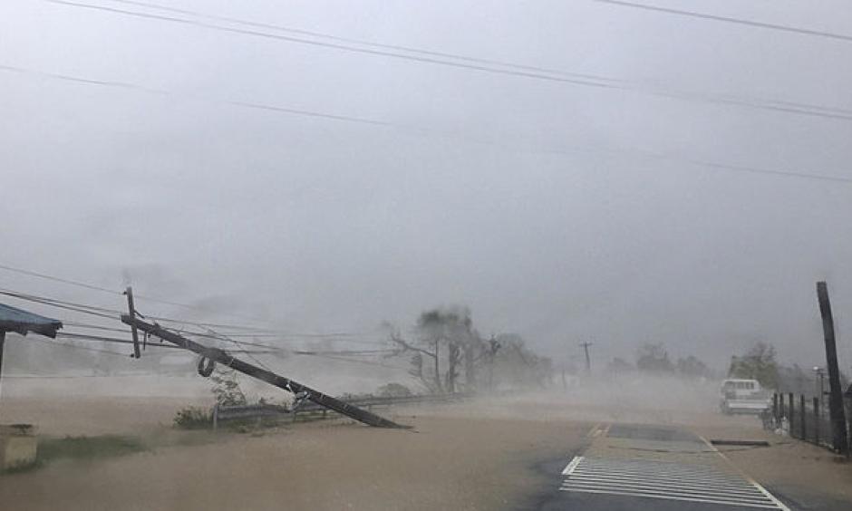 A toppled pole lays along a flooded road as heavy rains and wind from Haima battered Narvacan, Ilocos Sur, northern Philippines on Thursday, Oct. 20, 2016. Photo: Bullit Marquez, AP