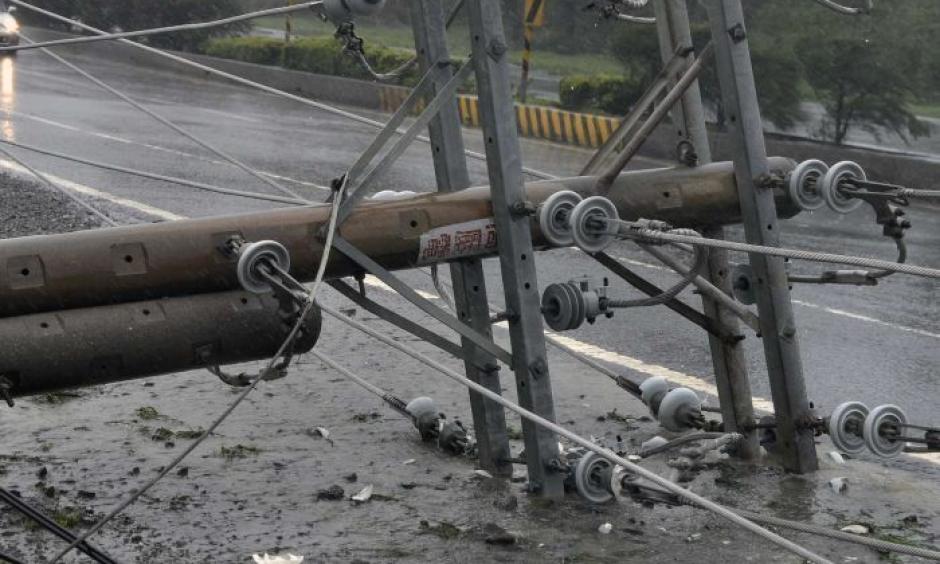 Cars drive past collapsed power lines, as super typhoon Meranti skirts Pingtung county in southern Taiwan. Photo: ABC News