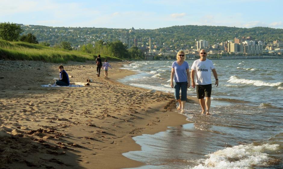 A couple walks along the Lake Superior shoreline at Park Point in Duluth. Photo: Dan Kraker | MPR News