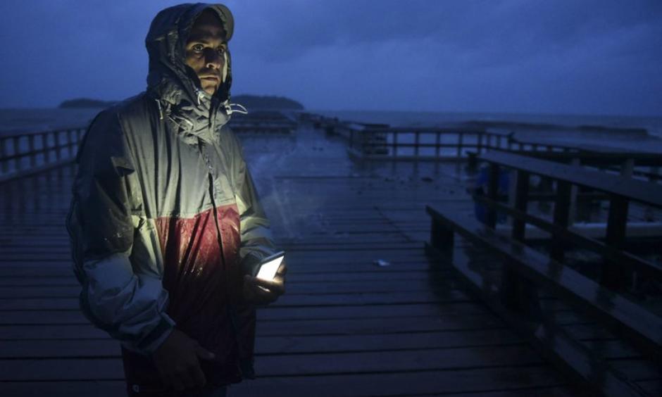 David Cruz Marrero watches the waves at Puncta Santiaga pier hours before the imminent impact of Maria, a Category 5 hurricane that threatens to hit the eastern region of the island with sustained winds of 165 miles per hour, in Humacao, Puerto Rico, Tuesday, September 19, 2017. Photo: Carlos Giusti, AP