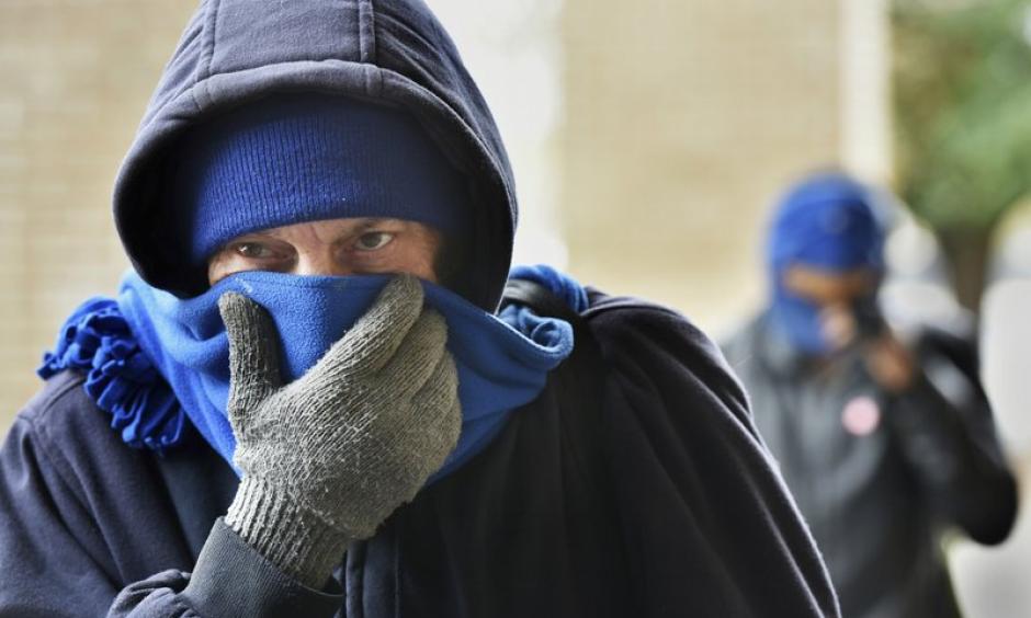 Chris McGuire tries to stay warm as he waits for a space at the City Rescue Mission on Tuesday, Jan 2, 2018, in Jacksonville, Florida. Photo: Will Dickey, The Florida Times-Union via AP
