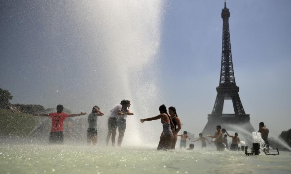Youngsters cool off at the Trocadero public fountain in Paris, Wednesday, June 26, 2019. Credit: Francisco Seco, AP