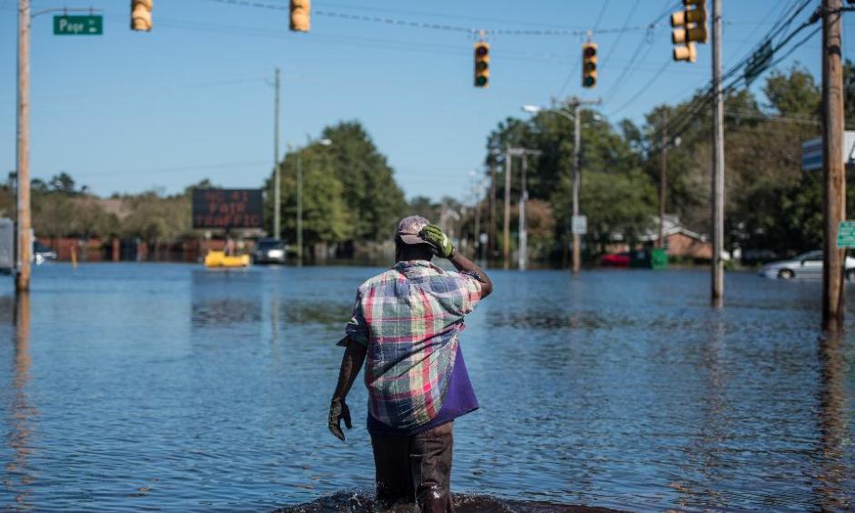 Chris Moore walks down Martin Luther King Blvd. on October 12, 2016 in Lumberton, North Carolina. Hurricane Matthew’s heavy rains ended over the weekend, but flooding is still expected for days in North Carolina. Photo: Sean Rayford/Getty Images