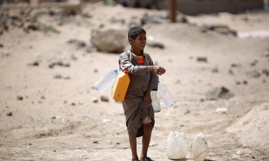 A boy carries buckets filled with water from a public tap amid an acute shortage of water, on the outskirts of Sanaa, Yemen. Water scarcity has been blamed for contributing to instability in the country. Photo: Hani Mohammed, Associated Press