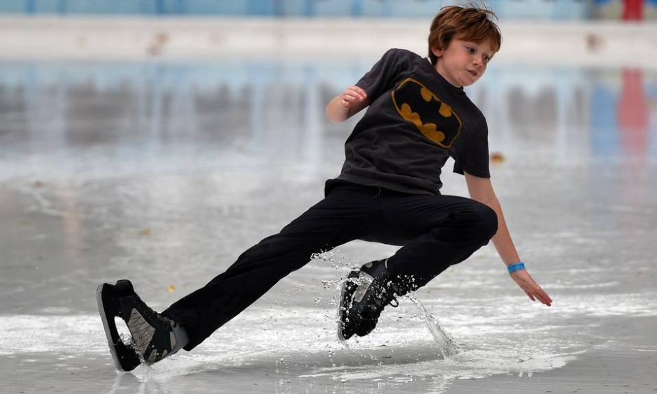 As New York City experienced an unseasonably warm month, a young skater slipped on a huge puddle of water from the melted ice at the Bryant Park rink. Photo: Timothy A. Clary, Agence France-Presse, Getty