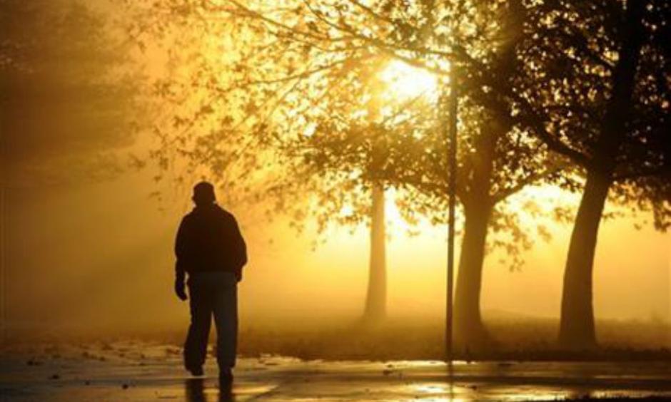 Chong O(cq), of Sherman Oaks, takes advantage of clearing skies to walk through the morning mist at Lake Balboa Park in Lake Balboa, Calif., Thursday, Jan. 7, 2016. The tail-end of a series of several El Nino-driven storms brought scattered showers and isolated thunderstorms to Southern California Thursday along with pounding surf and serious winds. (AP Photo/Michael Owen Baker)