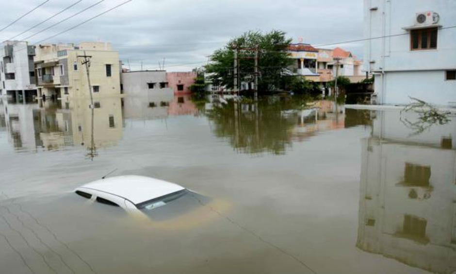 A car is submerged amidst water-logged houses in a rain-hit area of Chennai. (AFP)