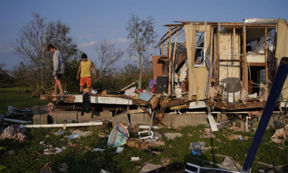 Aiden Locobon and Rogelio Paredes look through the remnants of their family's home destroyed by Hurricane Ida, September 4, 2021 in Dulac, LA. Credit: John Locher, AP