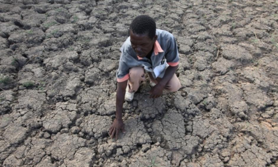 In this photo taken Sunday Jan. 29, 2016, Last Zimaniwa feels the broken ground at a spot which is usually a reliable water source that has dried up due to lack of rains in the village of Chivi , Zimbabwe. Zimbabwean president Robert Mugabe has declared a state of disaster as the country struggles to deal with a drought afflicting the region. Photo: Tsvangirayi Mukwazhi, AP