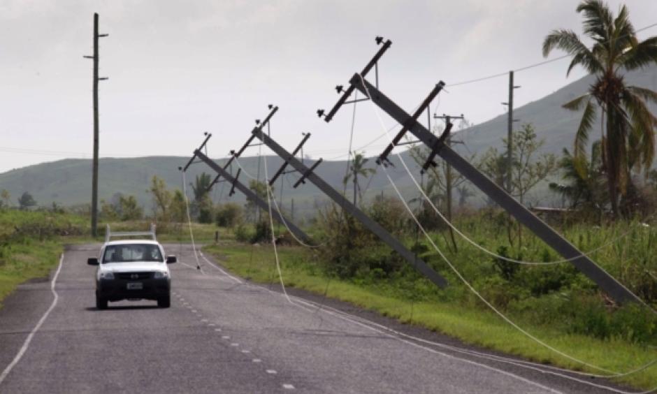 A car drives along Kings Road near Lautoka, Fiji, Wednesday, Feb. 24, 2016, where power poles lean over after cyclone Winston ripped through the island nation. The cyclone tore through Fiji over the weekend with winds that reached 177 miles (285 kilometers) per hour, making it the strongest storm in Fiji's recorded history. Photo: Brett Phibbs, AP