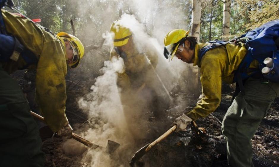 From left, Jason Robles, Vladimir Tamashiro-Loma and Louis Yu of the Team Rubicon 3 firefighting crew work to extinguish a hot spot at the Aggie Creek Fire. Image: Marc Lester/For The Washington Post