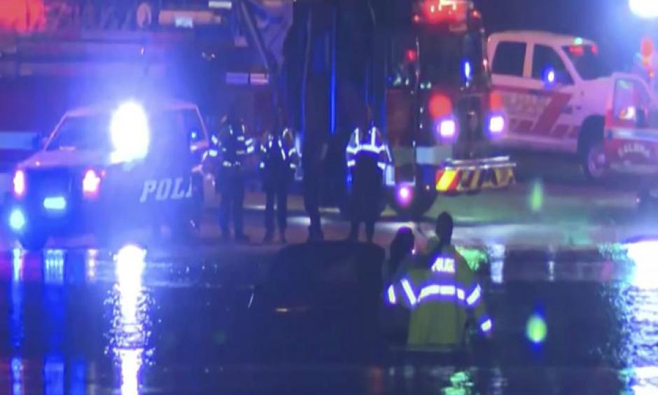In this image taken from video, emergency rescue teams attend to a vehicle stranded in floodwaters in Hoover, Alabama, late Oct. 6, 2021. As much as 6 inches (15 cm.) of rain fell in Alabama in about a day, unleashing flash floods that required some people to be rescued. (ABC 33/40 via AP)
