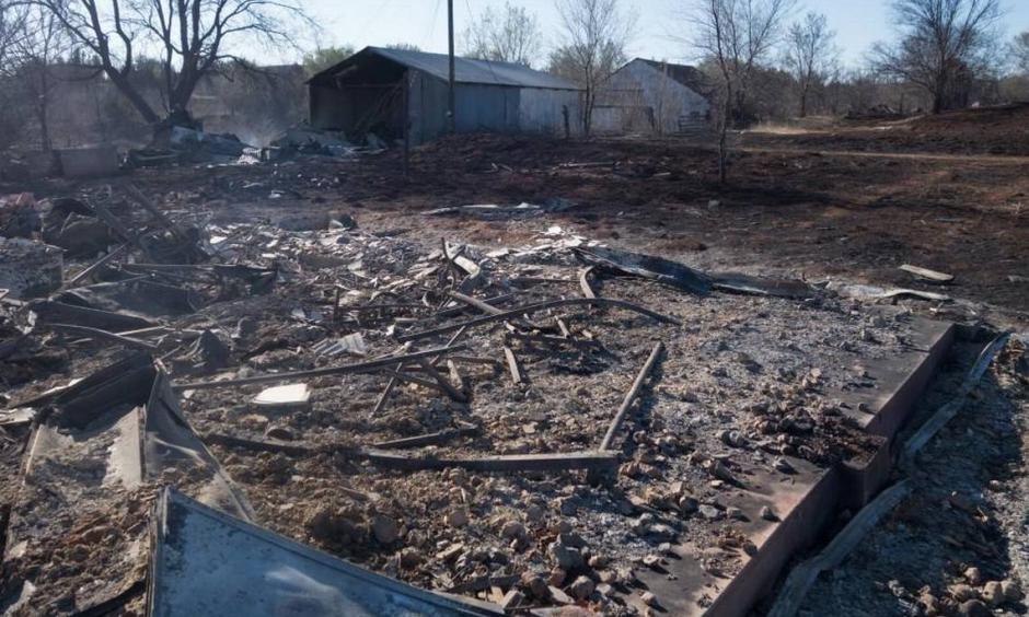 The remains of a homestead smolder Friday after a wildfire destroyed it and other buildings west of Medicine Lodge. Photo: Oliver Morrison, The Wichita Eagle