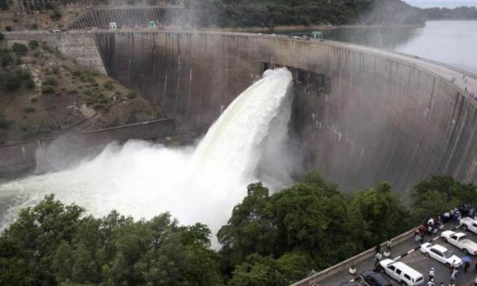 In this file 2008 photo, people watch as the spillway gates are opened at Kariba North Bank dam on Lake Kariba to reduce rising water levels as a measure to protect the dam. Photo: Mackson Wasamunu, Reuters
