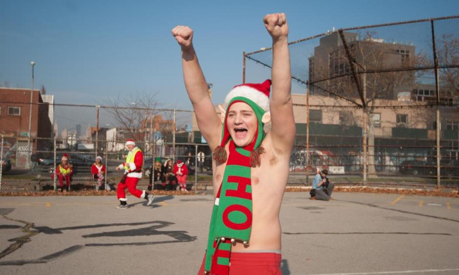 A man dressed as a Santa’s elf pumps his fists during a kickball game before the start of the annual SantaCon pub crawl Dec. 12, 2015, in Brooklyn. Photo by Stephanie Keith/Getty Images