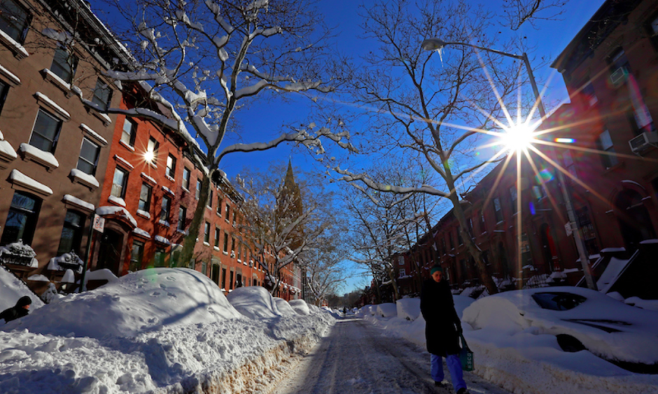 A woman walks down a snow-covered street in Brooklyn on Sunday morning, January 24, 2016. Most of New York City’s streets were cleaned up overnight after a huge snow storm slammed into the Mid-Atlantic states. Photo: Michael Heiman, Getty Images