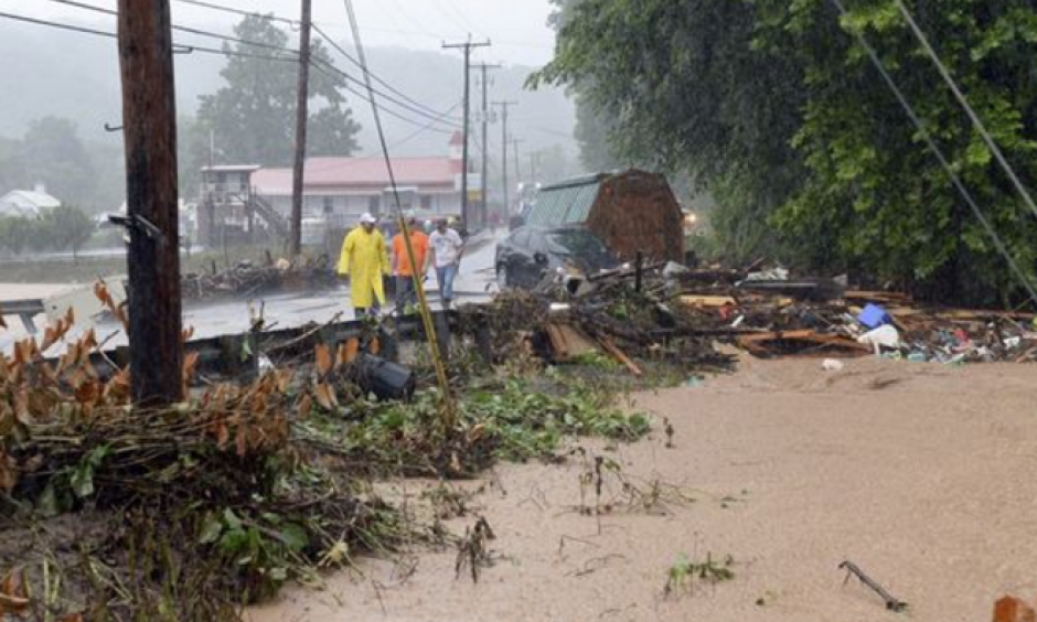 Debris from the Jordan Creek near Clendenin, W.Va., piles up against a culvert along U.S. 119 on June 23, 2016, before the creek's entry into the Elk River. Photo: Chris Dorst, Charleston Gazette, via AP