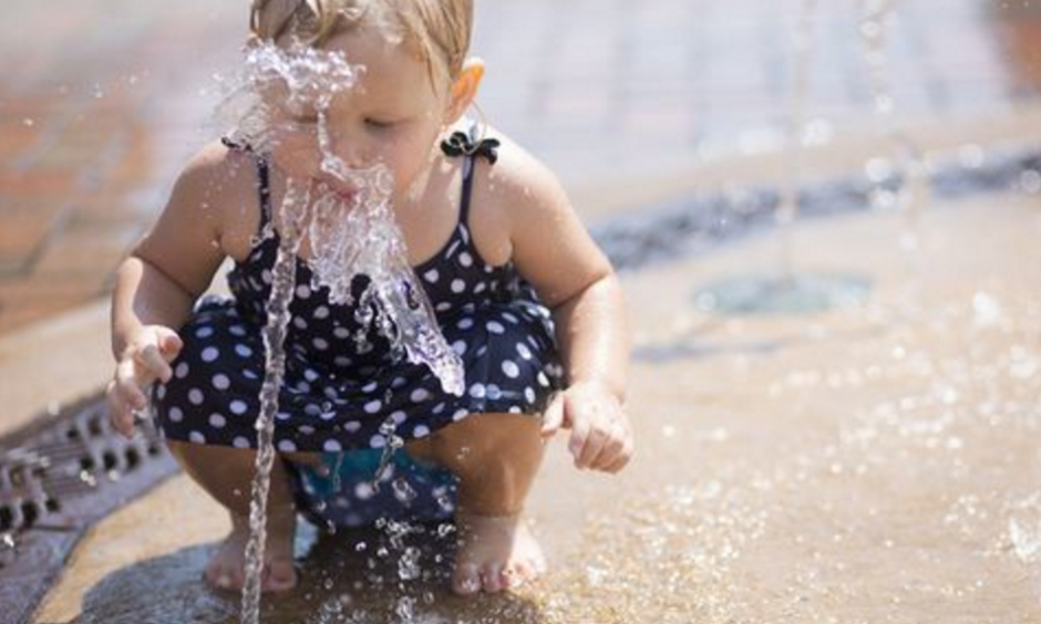 Athena Meeks, 2, tastes the water as she plays in the fountain at Mathias Mitchell Public Square in downtown Stevens Point, Tuesday, July 19, 2016. Photo: Megan McCormick / USA Today Network - Wisconsin