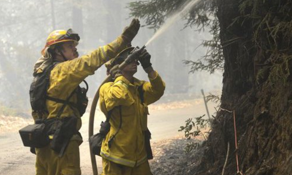 Cal Fire firefighters extinguish hotspots while fighting the Soberanes Fire in Palo Colorado Canyon on the northern Big Sur Coast on Tuesday July 26, 2016 in Big Sur, Calif. Photo: David Royal, AP
