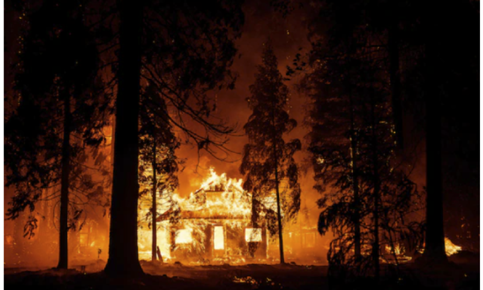 A home burns as flames from the Dixie fire tear through the Indian Falls neighborhood of unincorporated Plumas County, Calif., in July. The massive fire churned across nearly 1 million acres. (Josh Edelson/AFP/Getty Images)