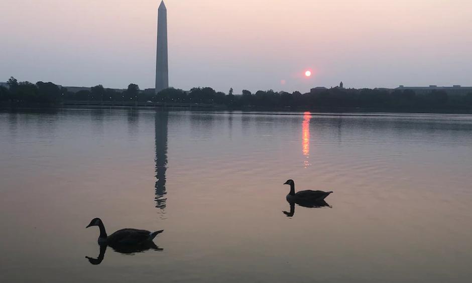 Skies were hazy and the sunrise was redder than usual in Washington on July 20 due to smoke transport from fires in the West. (Jeannie In D.C./CWG Flickr)