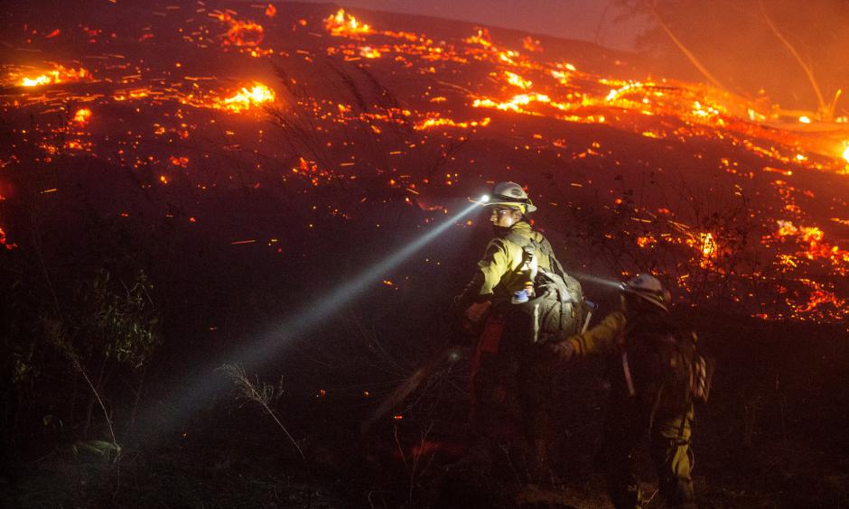 U.S. Forest Service firefighters cut brush near houses in northern Wenatchee, Wash., on June 28 as the Sleepy Hollow Fire spread quickly, fueled by low humidity and strong winds. Photo: Don Seabrook, Wenatchee World, AP