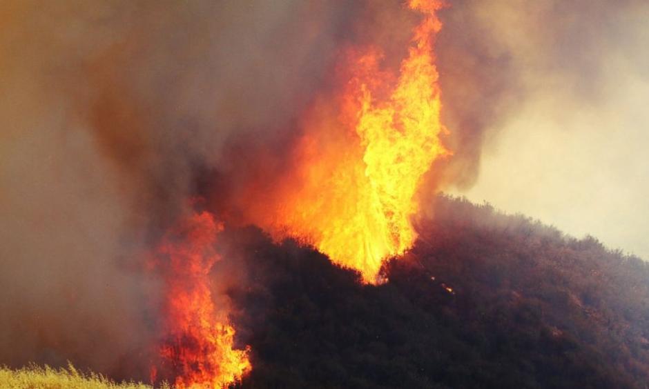 A wildfire in northern Los Angeles County gains ferocious new power two days after it broke out in Placenta Caynon Road in Santa Clarita, Calif., Sunday, July 24, 2016. Flames raced down a steep hillside "like a freight train," leaving smoldering remains of homes and forcing thousands to flee the wildfire churning through tinder-dry canyons in Southern California, authorities said Sunday. Photo: Matt Hartman / AP