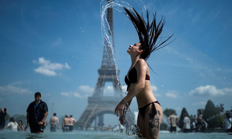 A woman wades in a fountain at Paris' Trocadero esplanade in an attempt to keep cool amid 100-degree weather in the French capital. Photo: KENZO TRIBOUILLARD, AFP/Getty Images