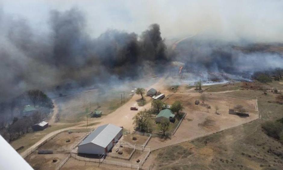 A wildfire rages in Sun City, Kansas, Wednesday after jumping across Highway 160 and crossing over from Oklahoma. Voluntary evacuations were made due to the threat of the fire. Photo: Deb Farris, KAKE News)