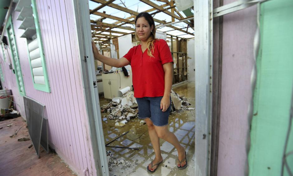 In this photo from Thursday, September 28, 2017, Sandy Nieves stands in the doorway of her heavily damaged home in the aftermath of Hurricane Maria in Yabucoa, Puerto Rico. Nieves said her greatest need is her home and especially her baby's bed. "We don't have anywhere to sleep, we don't have our stuff. We are all sleeping in one bed at my mom's house." Photo: Gerald Herbert, AP