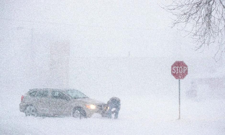 Daniel Marks digs his car out after getting stuck in a snowstorm Monday, Jan 22, 2018, in Norfolk, Neb. Photo: Ryan Soderlin, Omaha World-Herald via AP)