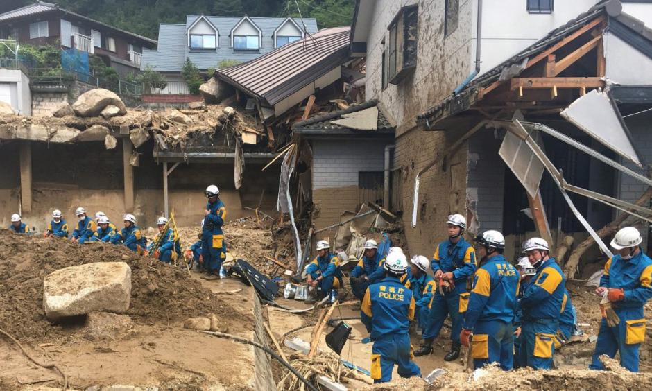 Emergency teams rest outside of structural damage caused by heavy rains, Monday, July 9, 2018, in Hiroshima, Japan. Credit: Haruka Nuga, AP