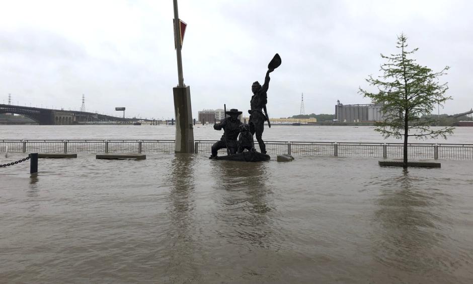 A statue of explorers Lewis and Clark is surrounded by floodwaters along the St. Louis riverfront on Thursday. Credit: Jim Salter, AP