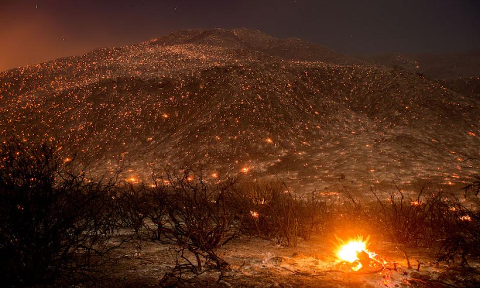 Embers from the Blue Cut fire smolder along Lytle Creek Road near Keenbrook, CA, on Wednesday, August 17, 2016. Photo: Noah Berger, AP