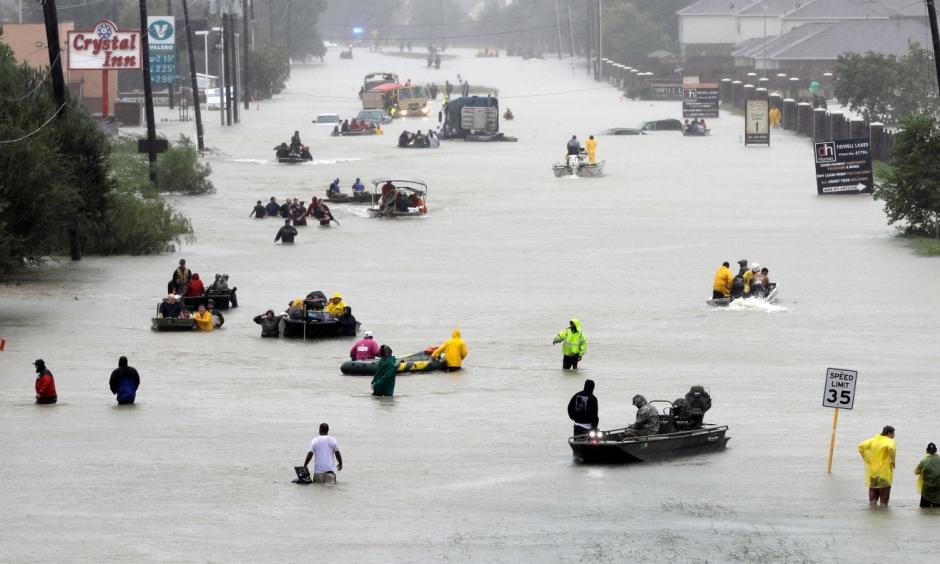 Rescue boats fill a flooded street as victims are evacuated from Harvey’s rising waters Aug. 28 in Houston. Photo: David J. Phillip, AP